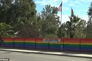 Lesbian woman discovers teens vandalizing her pride fence due to influence of hate groups