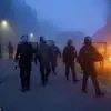 Riot Police Clash with Migrants in Gravelines, France as Projectiles and Fires Erupt During Early Morning Standoff