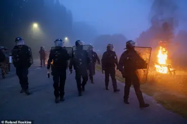 Riot Police Clash with Migrants in Gravelines, France as Projectiles and Fires Erupt During Early Morning Standoff